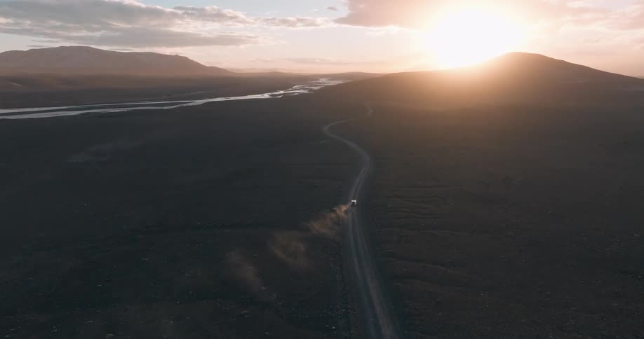 A car driving at high speed through the desert in the morning