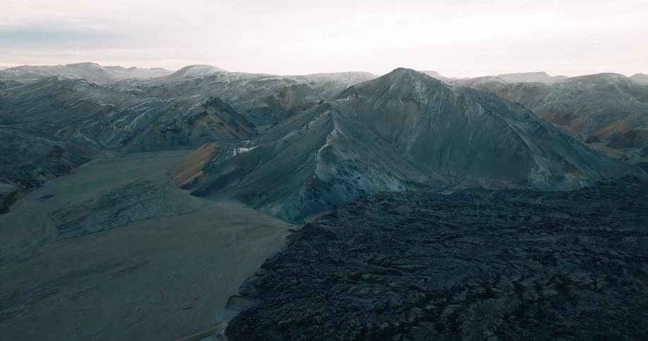 Aerial panorama of rocky mountain ranges and morning sky