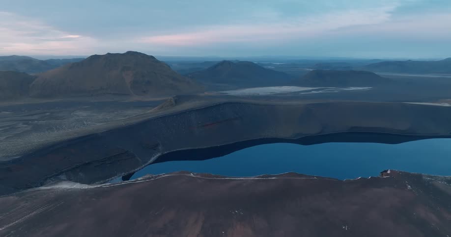 Rugged mountains and a calm lake reflecting the skys hues