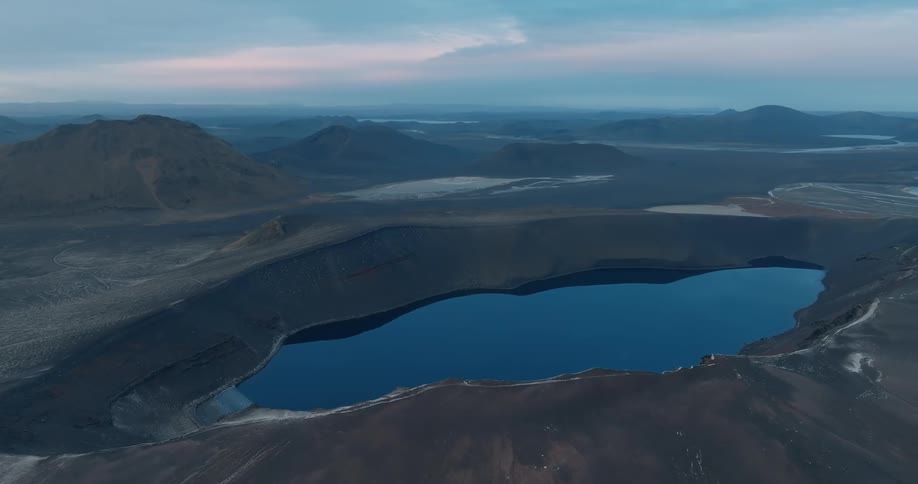 Aerial view of a crater lake on a desert landscape at morning