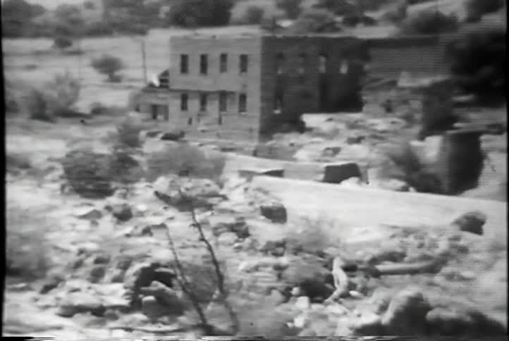 Rocks and trees near an abandoned building