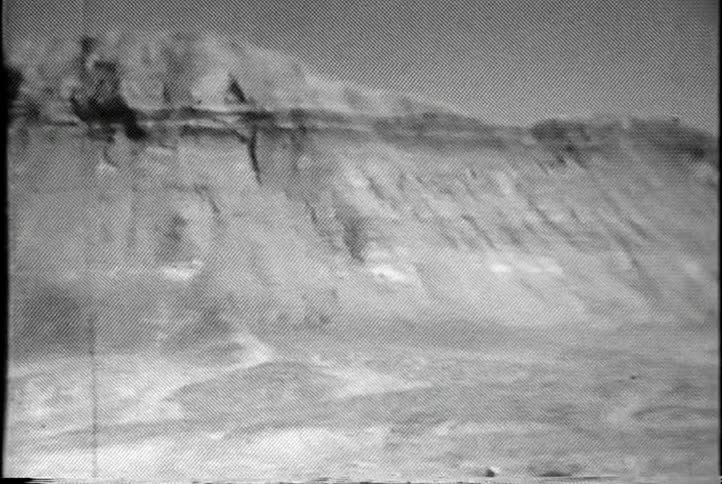 A sheer, rocky cliff during the day