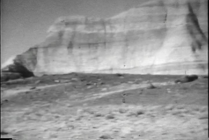 A weathered, striped rock in the desert