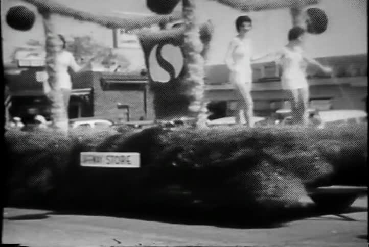 A group of women are riding on a float in a parade