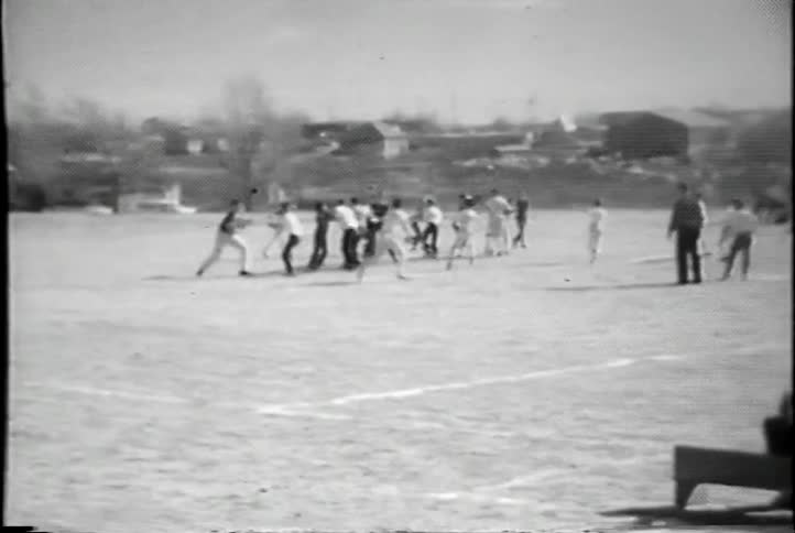 Group of men playing football on a field