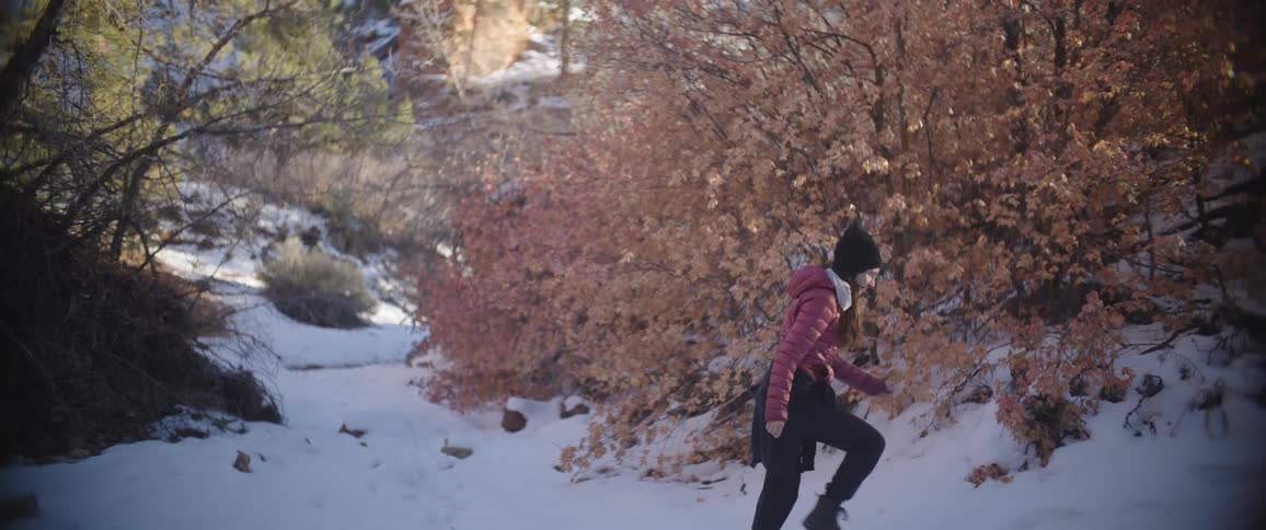 A girl is hiking in the snow
