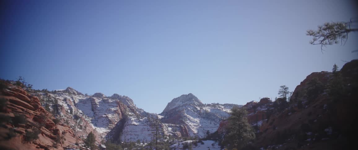 A valley between mountains covered in snow during winter