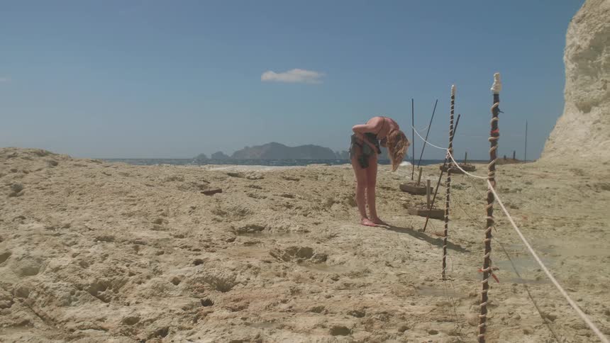 A blonde woman on a beach