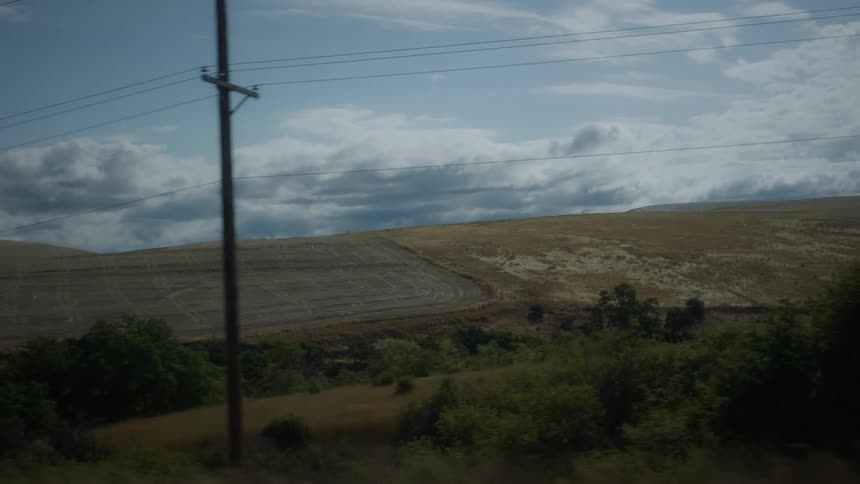 A view of a landscape with a hill in the distance