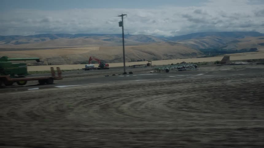 Two pieces of heavy machinery in a rural area