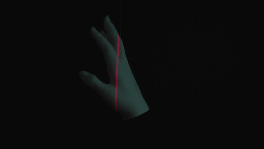A laser scans a persons revolving hand