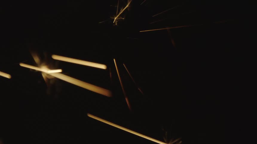 In the darkness multiple small sparks are launched in all directions