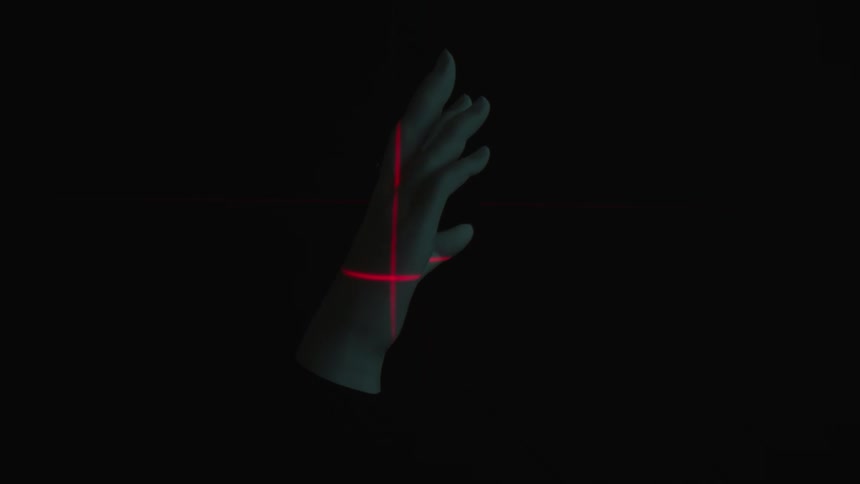 A human hand being scanned with a laser