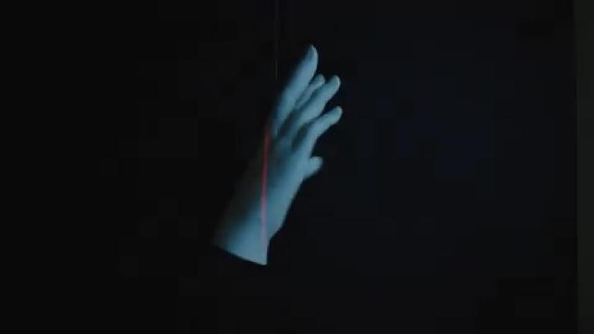 Projection of a 3d hand floating against a dark background