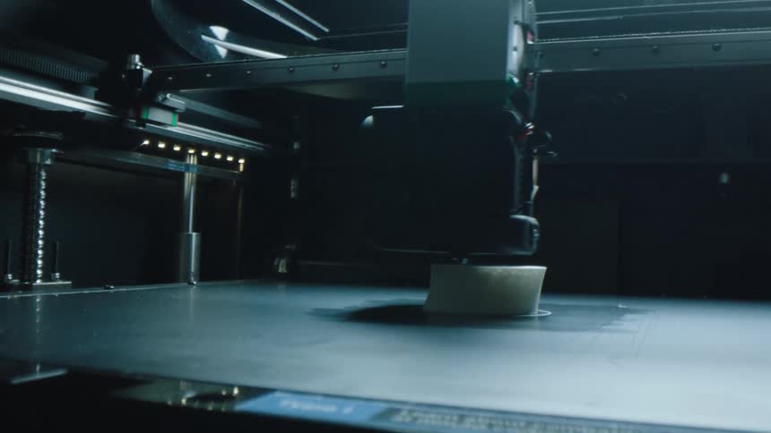 A threedimensional printer is printing a round object