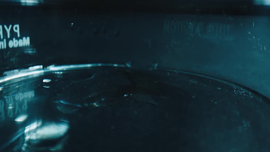 Water dropping into a metal tank