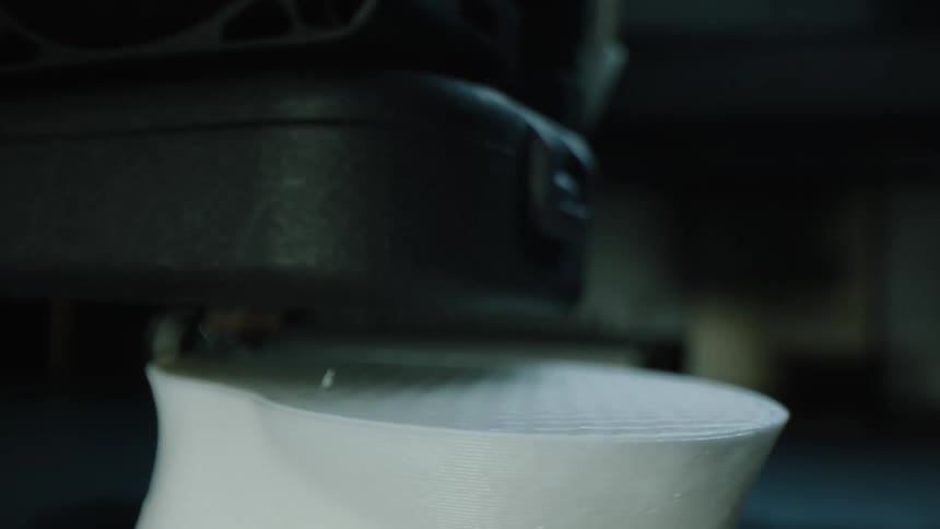Closeup of a machine performing coordinated movements on white plastic