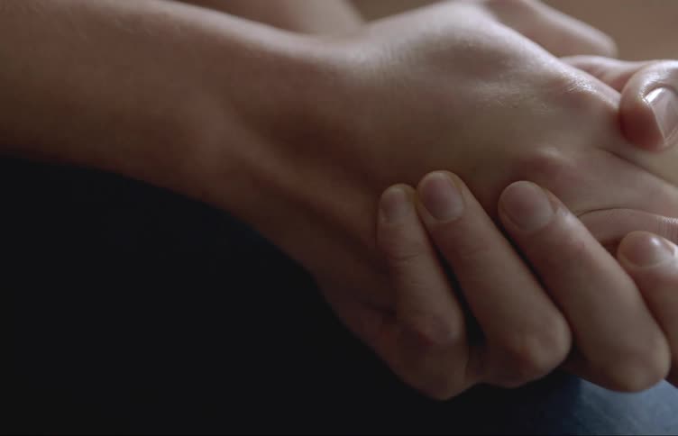 Woman massaging her own hands