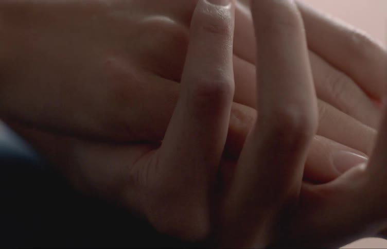 Womans hands interlacing fingers