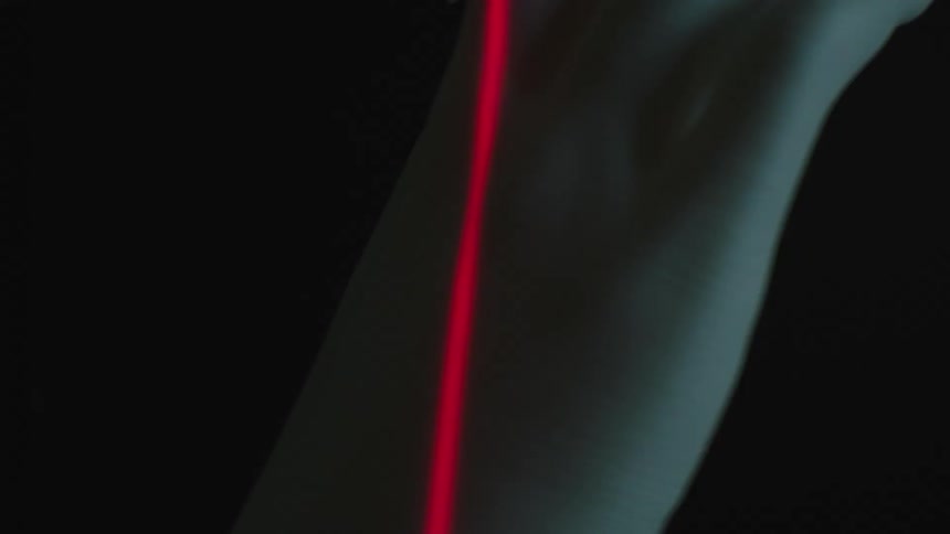 Red laser amidst a rotating plaster hand