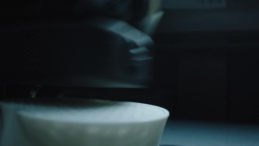 Machine performing circular movements on an abstract white object