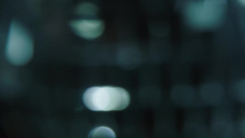 Object with ridged metallic surface reflects light as it rotates