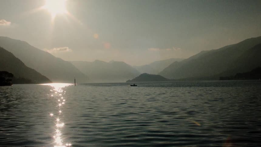 Sunlight reflects off of the surface of a large body of water an shimmers brightly
