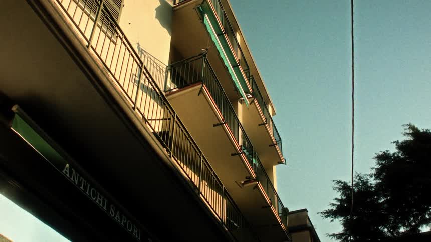 Upward view of the facade of a residential building with balconies