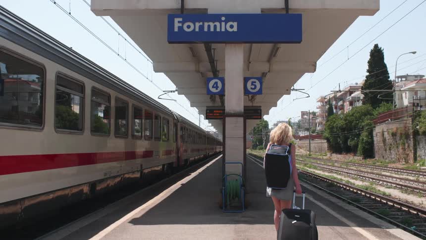 Woman walking in a train station during the day