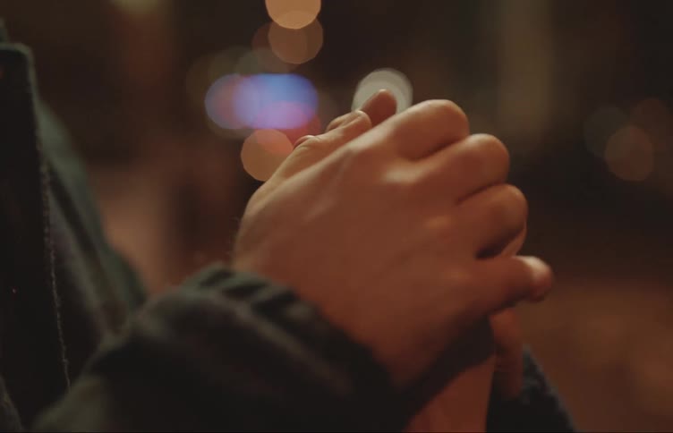 Two adults are clasping and squeezing each others hands