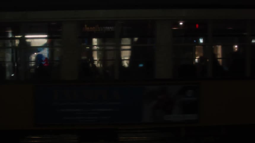 People sitting on public transport pass through the city streets