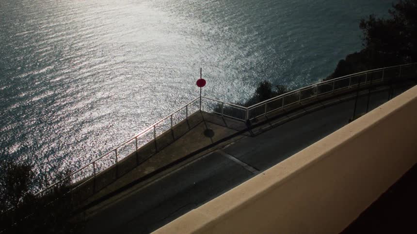 View of a street next to the sea with solar reflection