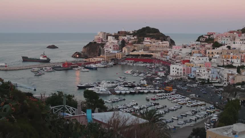Aerial of the harbor of a coastal city during sunset