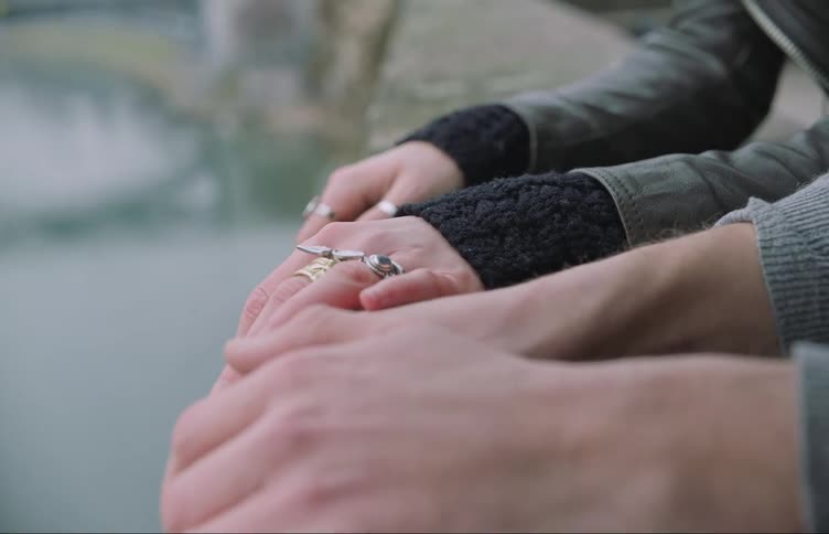 A woman touches a mans hand