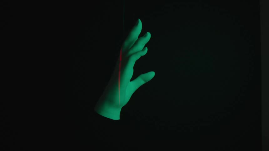 Abstract plaster hand rotating with lights reflecting