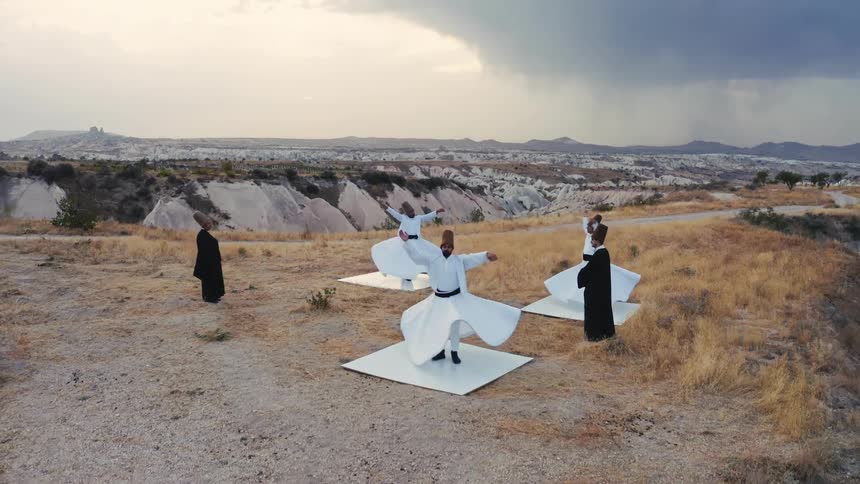 Epic drone shot of sufi whirling dervishes feels cinematic in the Cappadocia desert region of Turkey