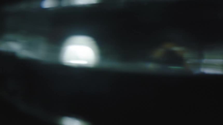 A shiny and reflective object spins incredibly fast and reflects light
