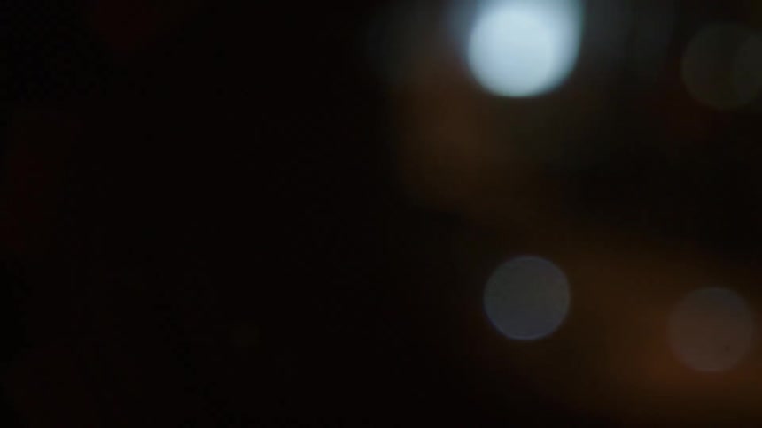 Blurry video at night of small reflections of lights