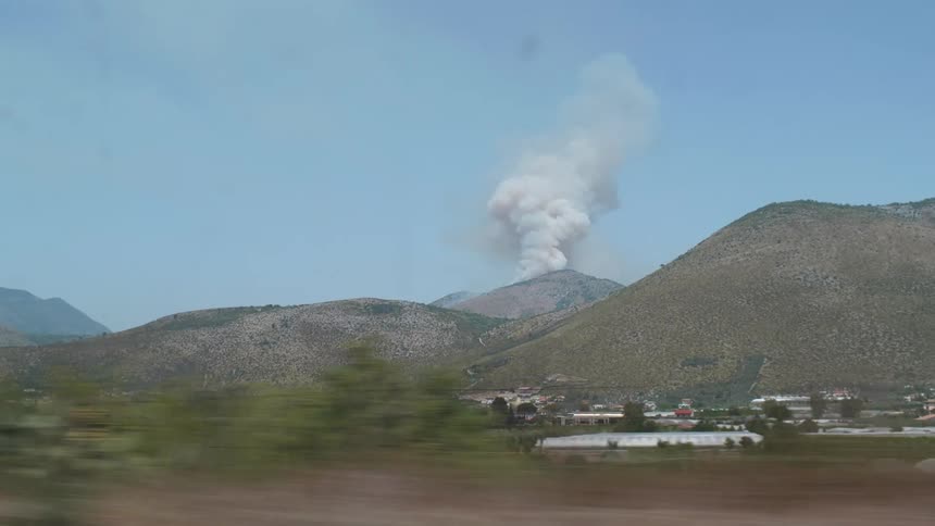 A Volcano in the mountains near a small town in the countryside