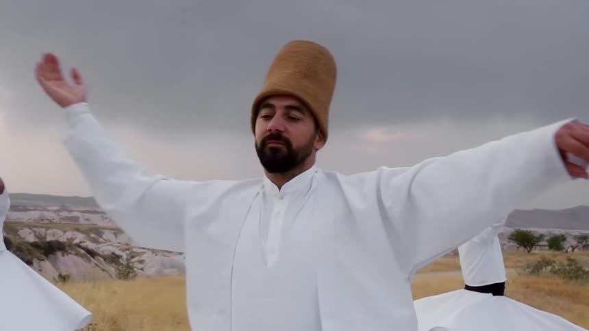 Dynamic shot of three spinning and dancing men in iconic Cappadocia region