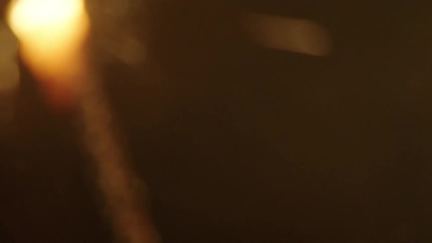Closeup of a candle burning and sparking