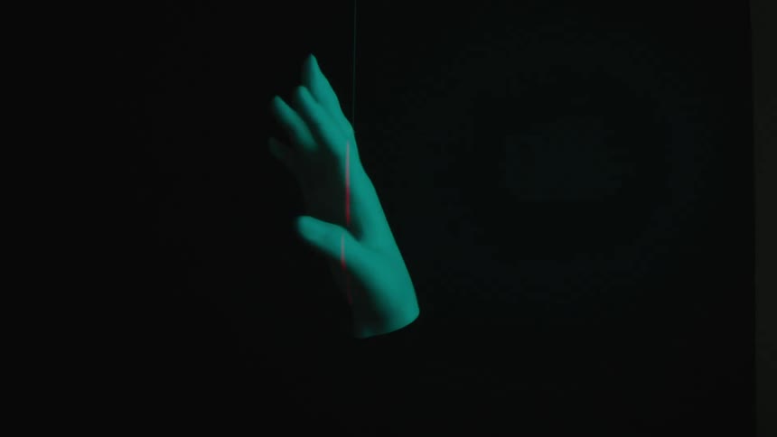 3d projection of a blue floating hand against a dark background