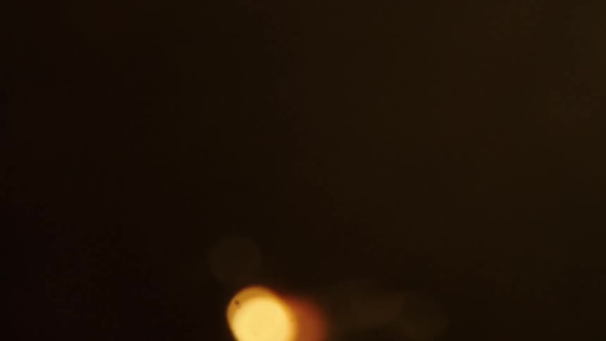 Sparks are ejected upwards into the darkness of nighttime