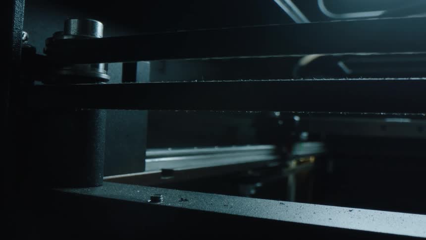 A pair of belts on a machine move back and forth as a probe changes position