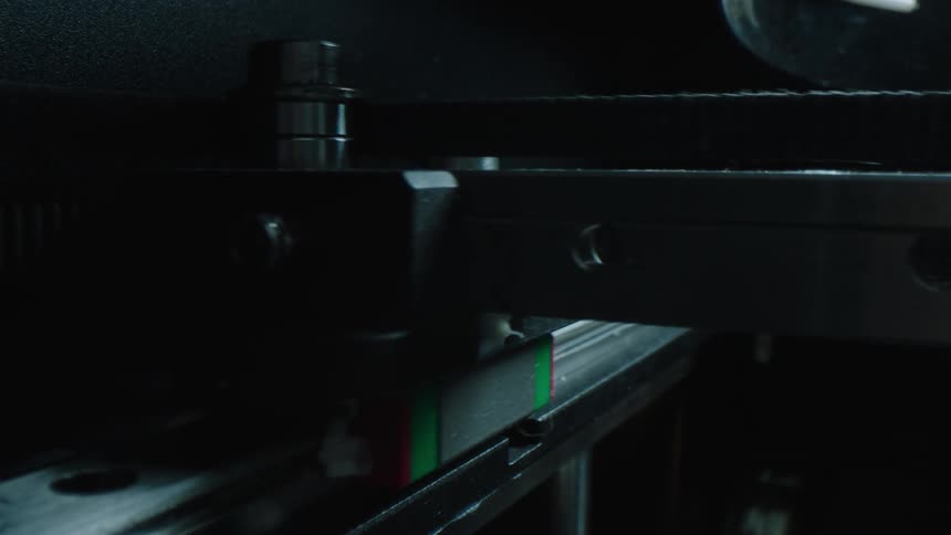 A robotic arm on a printer moving left and right