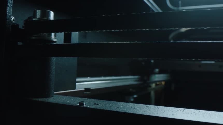 A machine with a pulley pulling a strip back and forth
