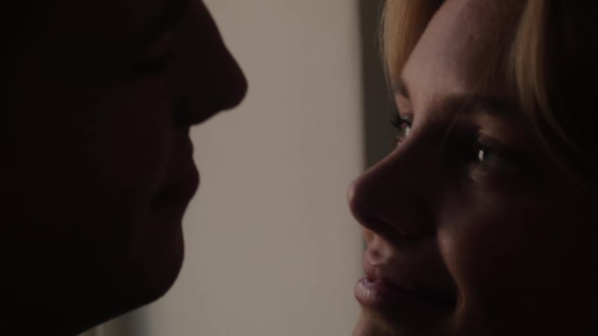 Portrait of a woman hugging and looking at her partner looking romantically