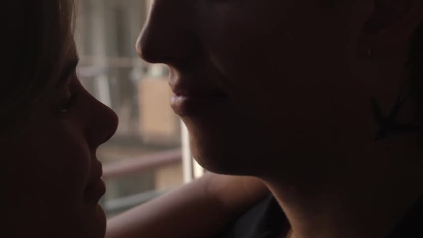 Closeup of a couple hugging and kissing