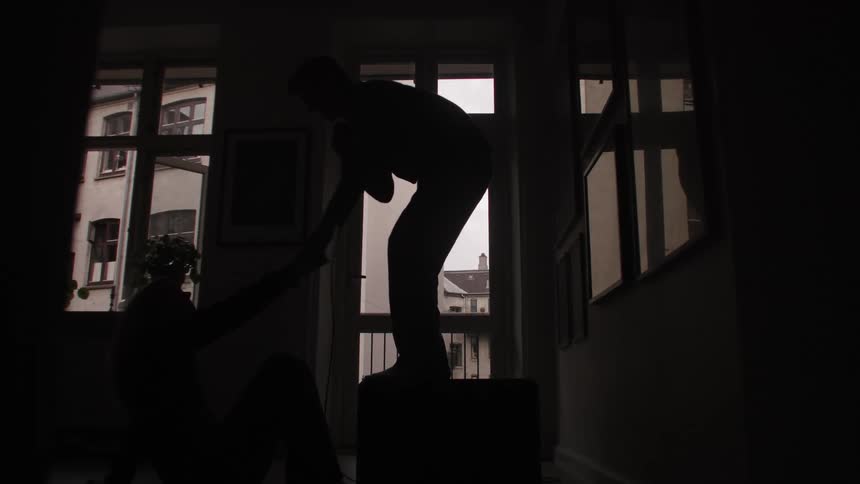 A man singing to a woman in a room