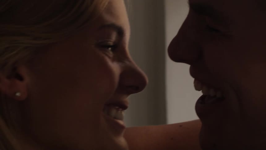 A couple of a blonde woman and a man who are talking and looking at each other passionately